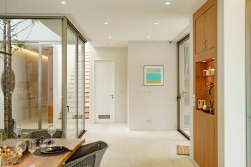 Modern dining area with glass doors and natural lighting