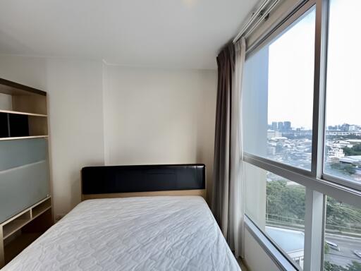 Bright bedroom with large window and city view