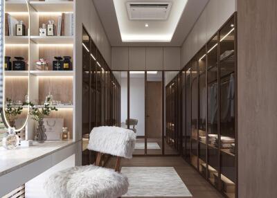 Spacious walk-in closet with built-in wardrobes, vanity area, and modern lighting