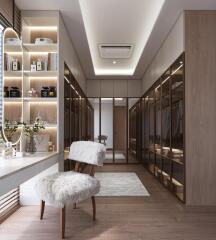 Spacious walk-in closet with built-in wardrobes, vanity area, and modern lighting