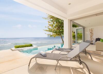 Ocean view from patio with pool and lounge chairs