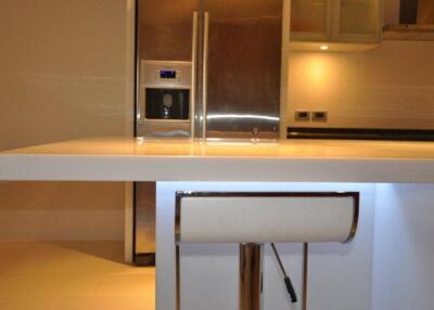 Modern kitchen with countertop and stainless steel fridge