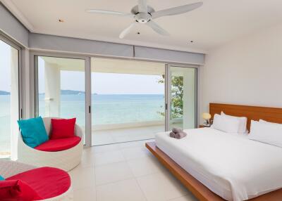 Bright bedroom with large windows and ocean view