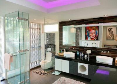 Modern bathroom with glass shower and double sinks