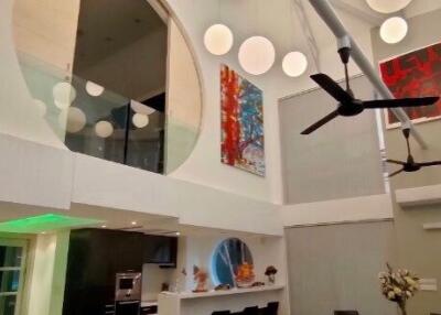 Modern living area with balcony and high ceilings