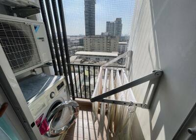 Outdoor laundry area with a washing machine and drying rack