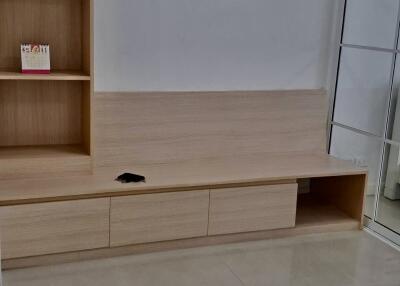 Minimalist living room with built-in wooden shelving and drawers