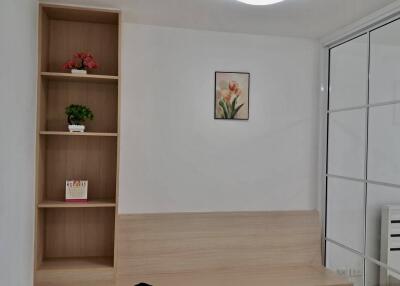 Bedroom with a bookcase, wall art, and glass closet