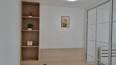 Bedroom with a bookcase, wall art, and glass closet