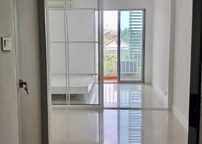 Bright hallway with glass door leading to a balcony