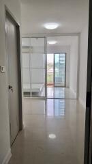 Bright hallway with glass door leading to a balcony