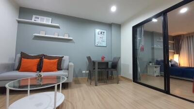 Modern living room with gray sofa and dining area