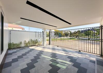 Covered parking area with modern tiling and gated entrance