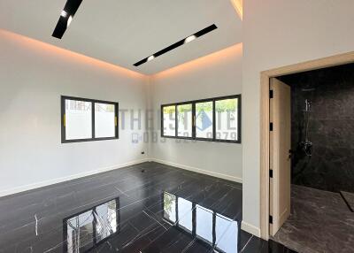 Modern living area with recessed lighting and adjacent bathroom