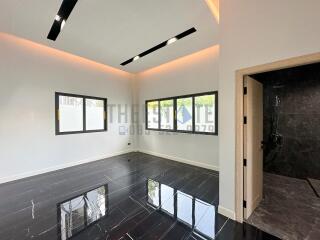 Modern living area with recessed lighting and adjacent bathroom