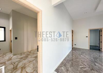 Spacious and well-lit hallway with marble flooring