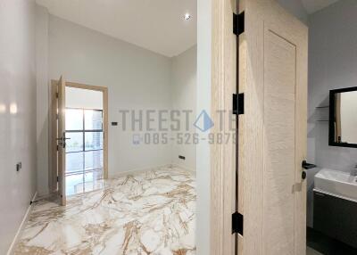 Modern bathroom with marble floor and a door leading to a balcony