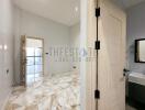 Modern bathroom with marble floor and a door leading to a balcony