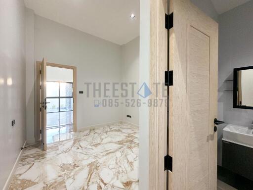 Modern bathroom with marble floor and a door leading to a balcony