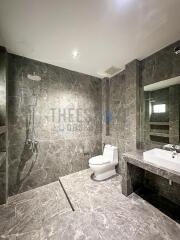 Modern bathroom with marble tiles and walk-in shower