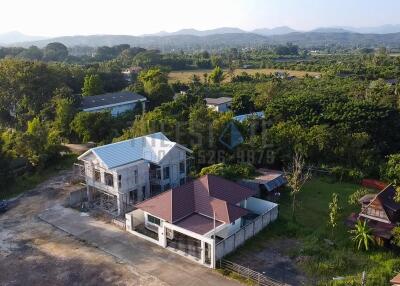 Aerial view of a residential property and surrounding landscape