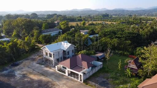 Aerial view of a residential property and surrounding landscape