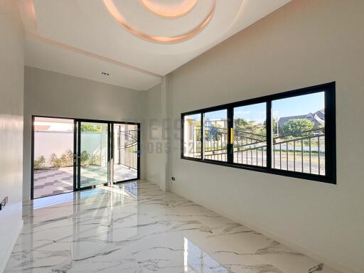 Spacious living area with large windows and modern flooring