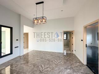 Spacious and modern living room with stylish chandelier and large marble floor tiles