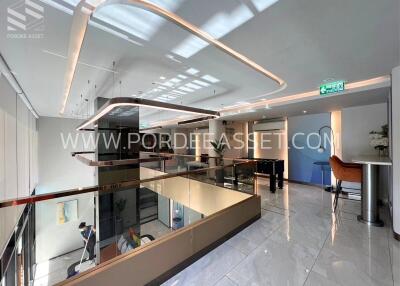 Modern office lobby with glass railings and contemporary lighting