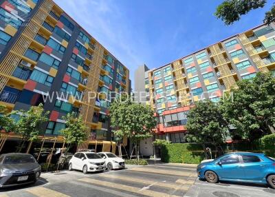 Modern apartment buildings with colorful façades under a clear blue sky