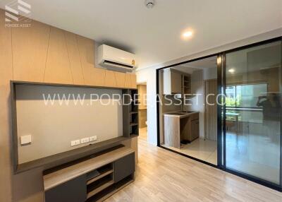 Modern living room with hardwood flooring and built-in storage