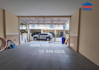 Clean garage with car parked inside and open view to the outside