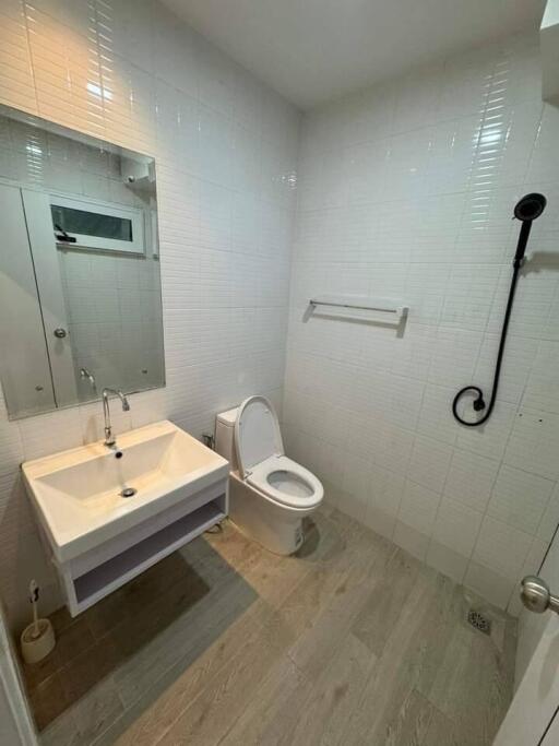 Modern bathroom with white tiles and fixtures