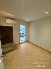 Modern bedroom with wooden flooring and large window