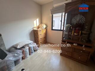 Neat bedroom with wooden furniture and natural light