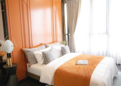 Bedroom with double bed and orange accent wall