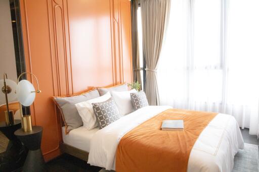 Bedroom with double bed and orange accent wall