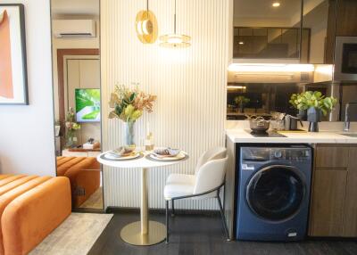 Modern kitchen with dining area and laundry facility