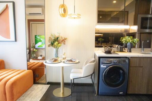 Modern kitchen with dining area and laundry facility