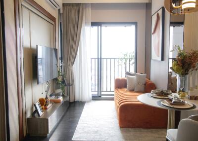 Cozy living room with orange sofa and balcony view