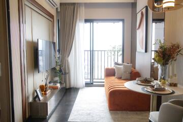 Cozy living room with orange sofa and balcony view