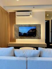 Modern living room with TV and cozy seating