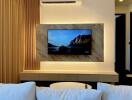 Modern living room with wall-mounted TV and comfortable sofa