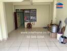 Living room with white tile flooring and some storage items