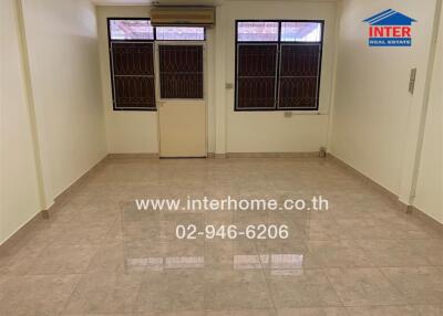 Unfurnished living room with large windows and tiled floor