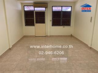 Unfurnished living room with large windows and tiled floor