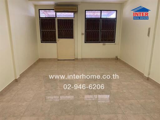 Unfurnished living room with large windows and tiled floor