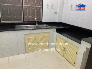 Simple kitchen with sink and storage cabinets