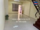 Spacious living room with tiled floor and staircase