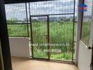 Balcony with metal grill and view of greenery